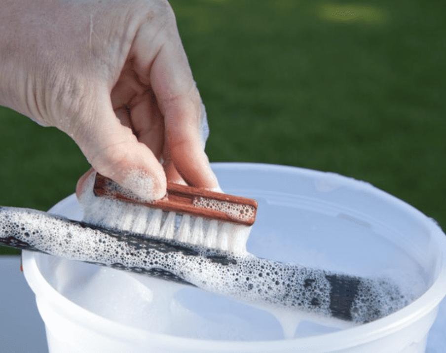 scrubbing a golf grip clean